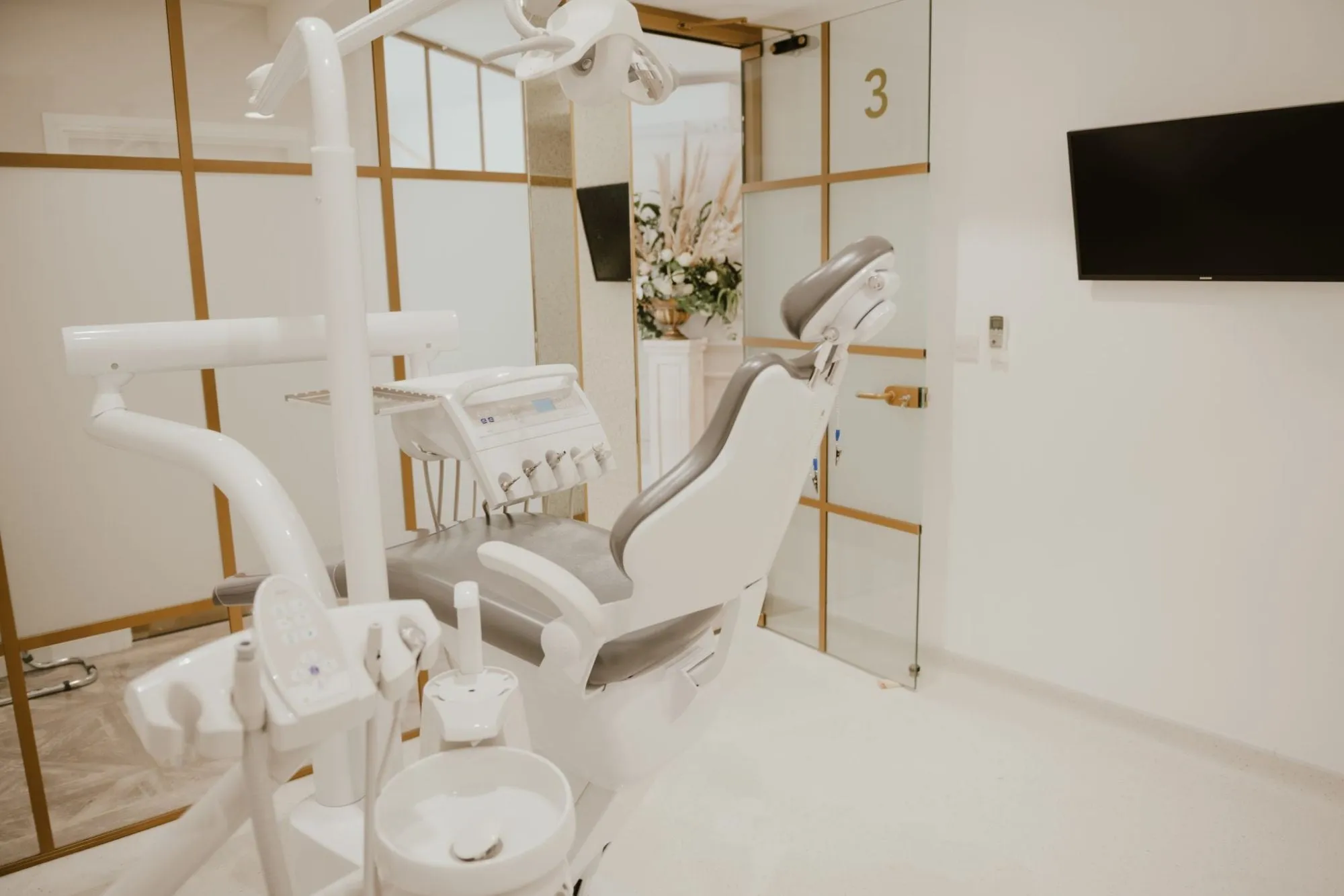 White and gold surgery behind brass-framed glazed screens at Blossom Cosmetic Clinic, York