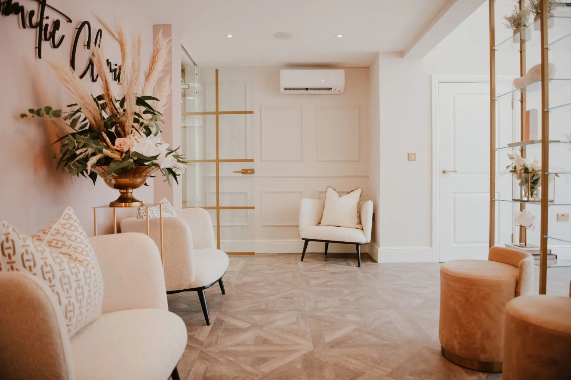 Blush waiting room with boucle chairs, dried flowers and parquet floor at Blossom Cosmetic Clinic, York